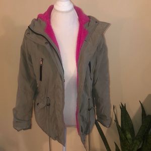 Green utility jacket with bright pink fur inside